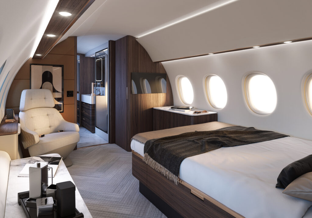 Falcon 10X interior, with a queen bed, a lounge chair and a side table in browns and creams