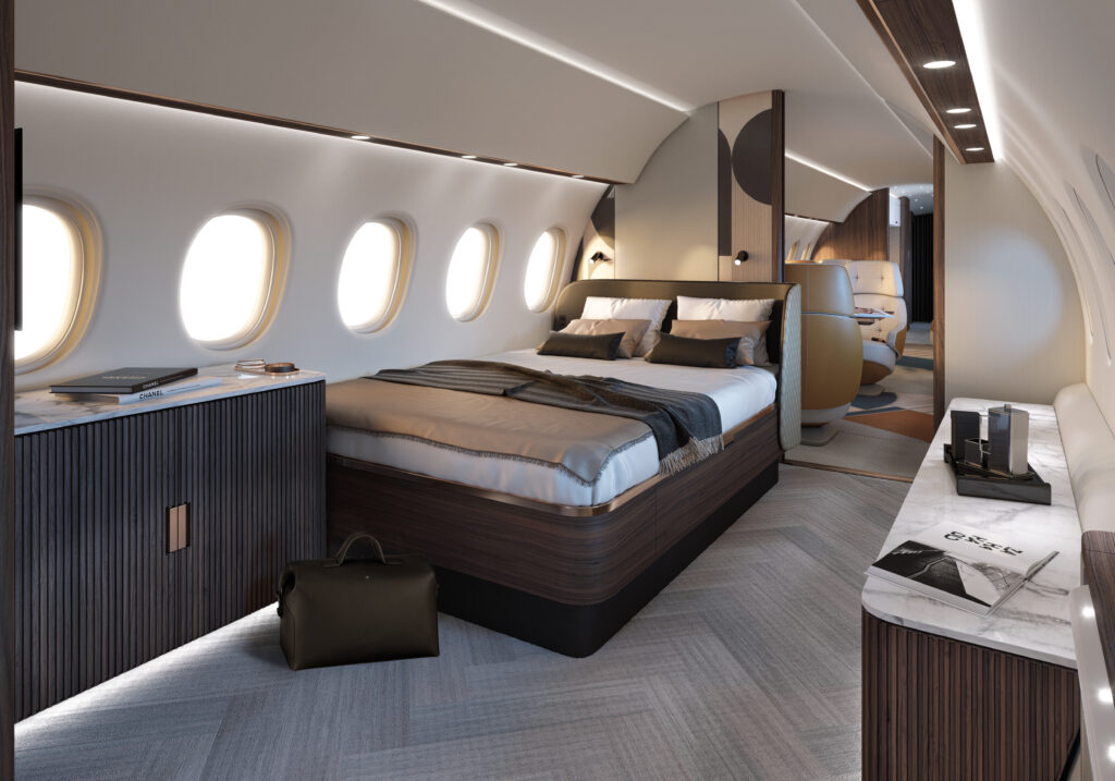 Falcon 10X with a queen bed suite. White and brown pillows, blankets and decor.