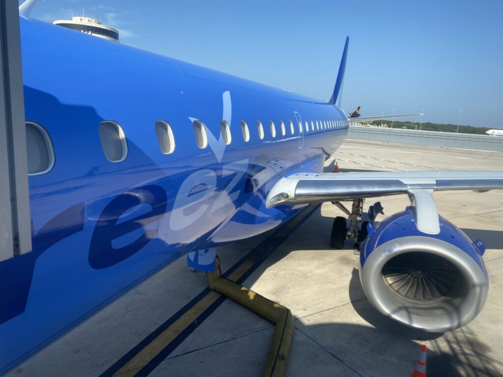 A sparkling Breeze E-Jet in bright blue livery, with a blue sky as backdrop