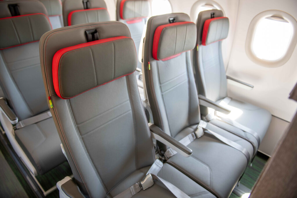 Tap Airlines Airbus hybrid configuration with Recaro. Aircraft seats are grey with red trim on the headrest.