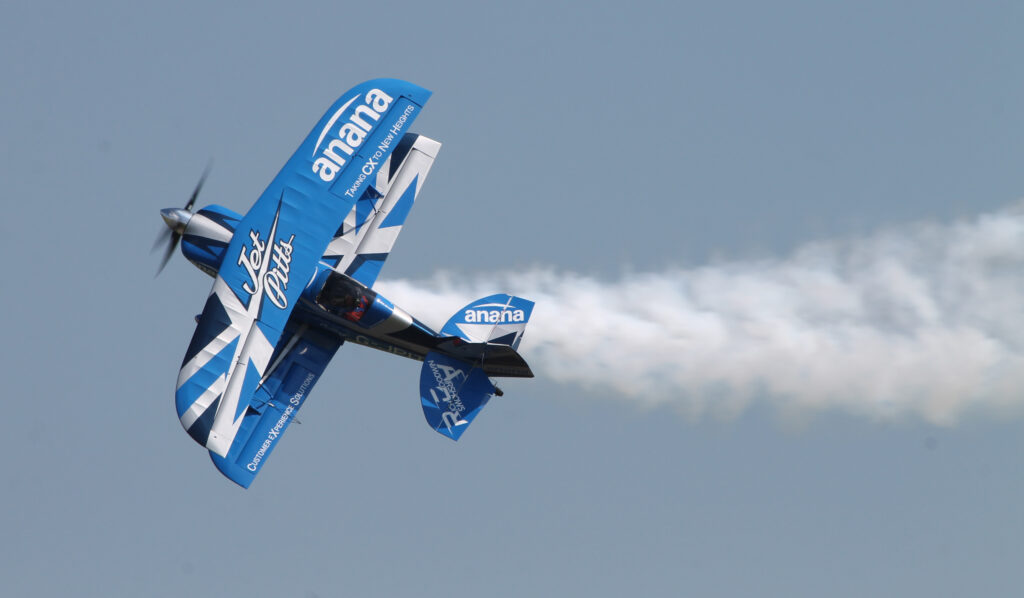 The ‘Jet Pitts’ aircraft in-flight. Blue and white livery against a blue sky. 