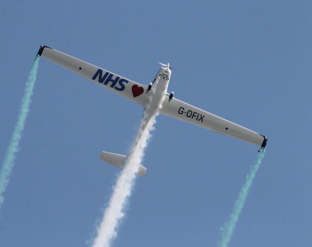 The Grob 109 in-flight against a clear blue sky. 