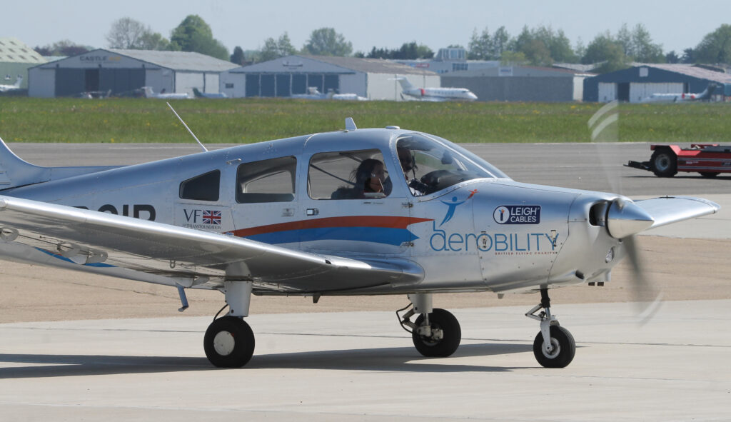 One of Aerobility’s Warriors taxies back at the end of Sophie’s return to flight. The aircraft features Aerobility's logo.