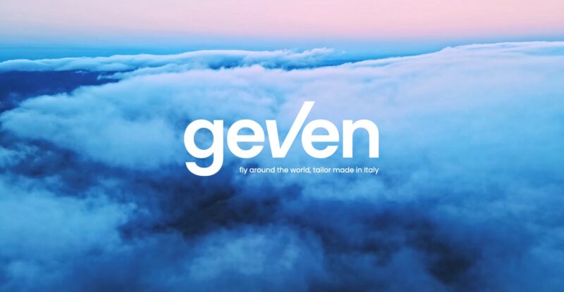 Soft blue clouds with a pink sky above. The word Geven is at the forefront of the image in the centre.