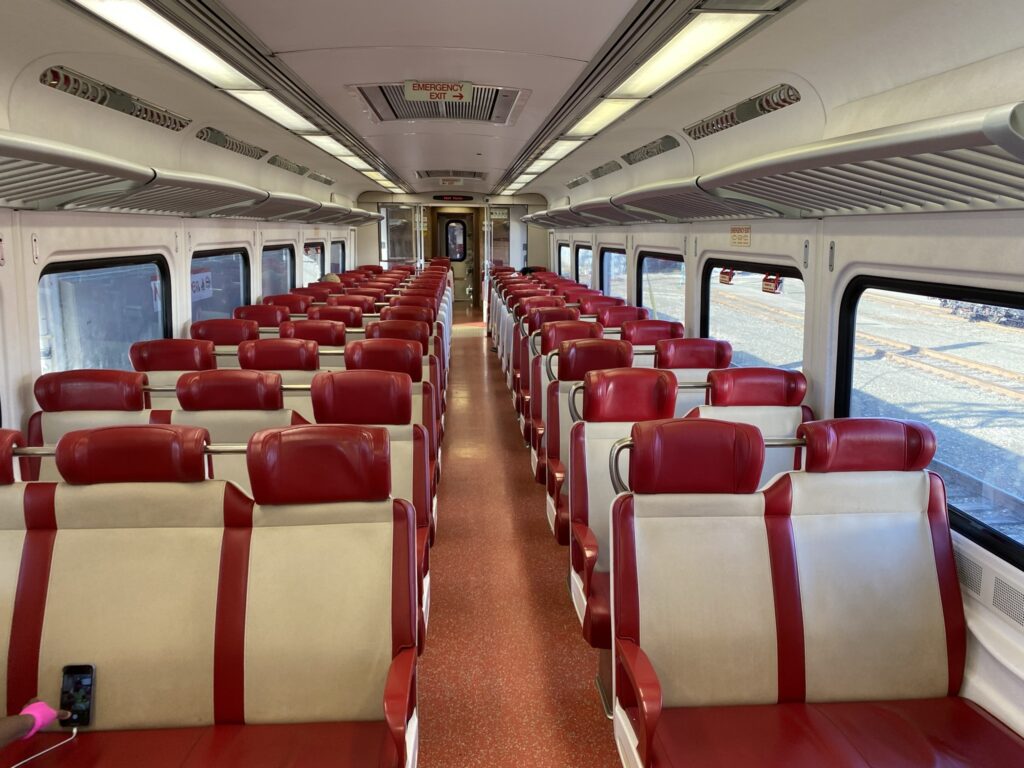 Interior of the Kawasaki built M8 electric railcar. Red trimmed white seats.