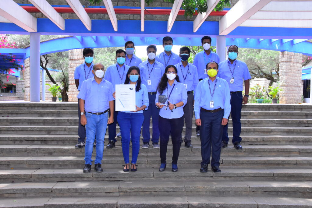 Tata Advanced Systems team members all standing on a set of stairs posing for the photo with the award received. Image: FACC