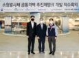 3 men with masks on posing for a photo