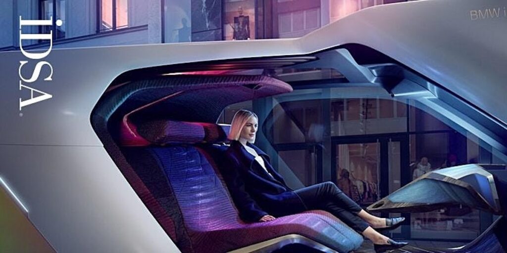 A woman seats in a futuristic vehicle 