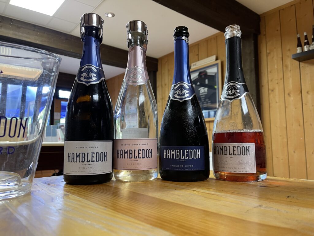 4 wine bottles displayed on a wooden table