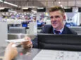 Brussels Airlines crew member checking a passenger in at the desk,