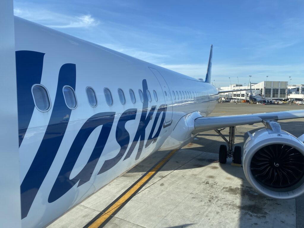 The Alaska A321neo parked at the gate; a close-up of the side of the aircraft and the engine