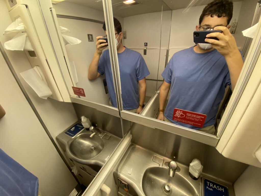 The author, Jason Rabinowitz, taking a mirror selfie in the aircraft lavatory.