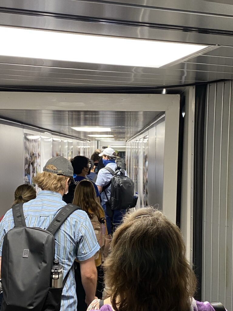 People in the jetbridge, readying to board the Delta Aircraft.