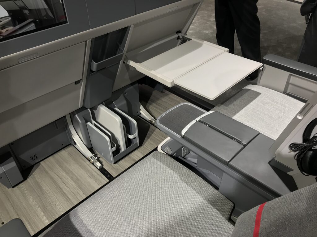 Cathay Aircraft seats, showing a view of the footwell space and tray table.