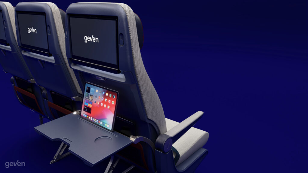 Tray table and PED holder for the Elemento Economy class seat by Geven rendered on a blue background.