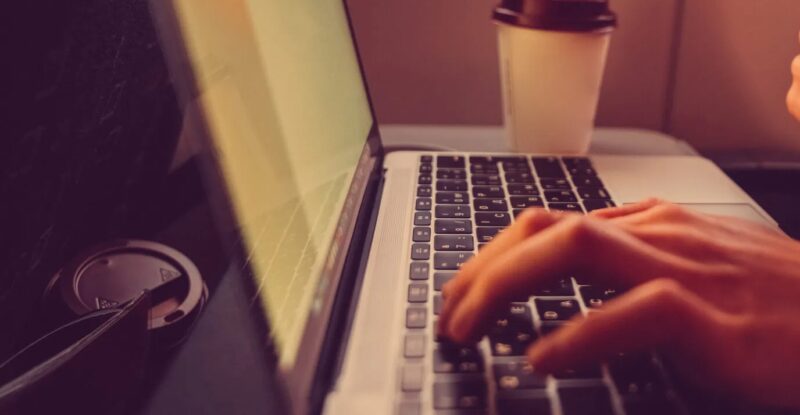 Passenger shopping online with credit card in the airplane