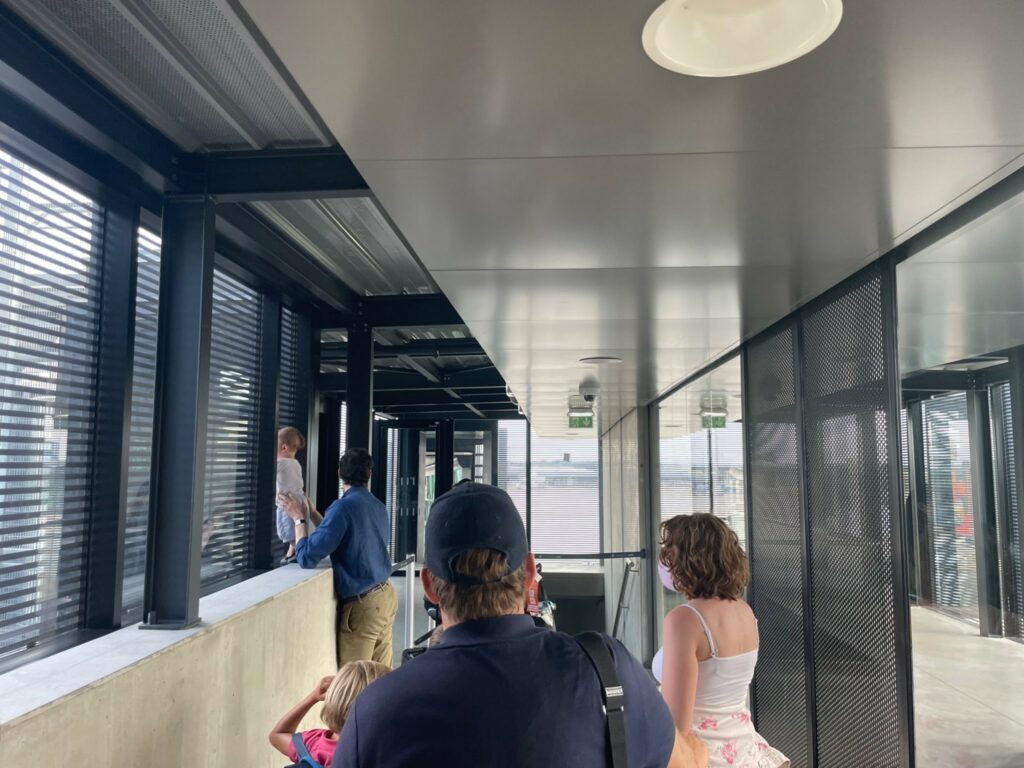 Passengers waiting to board a British Airways aircraft on the jet bridge