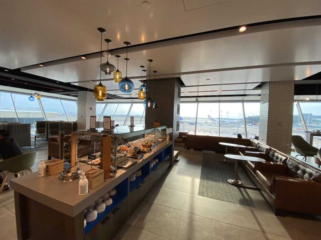 Alaska Airlines' lounge at JFK with a buffet prominent in the center