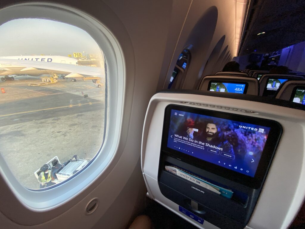 A close up view of United Airlines' seatback IFE and the window