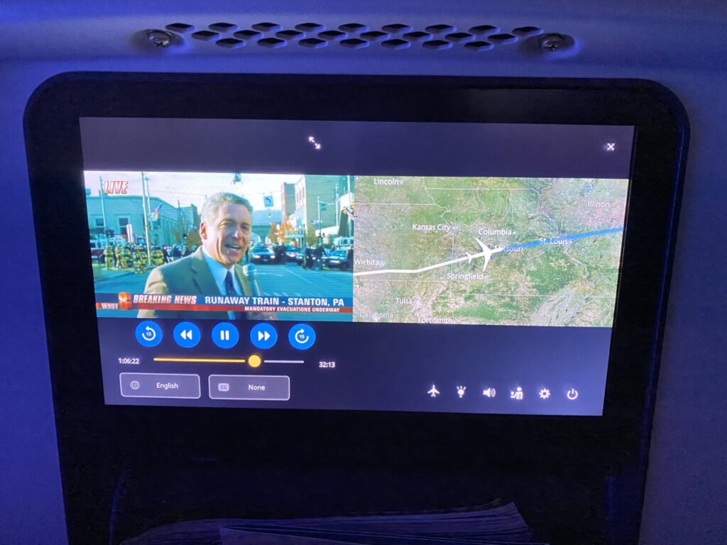 Panasonic seatback IFE on United Airlines 787-9 economy class seat. Showing the news on one half of the screen and a moving map on the other.