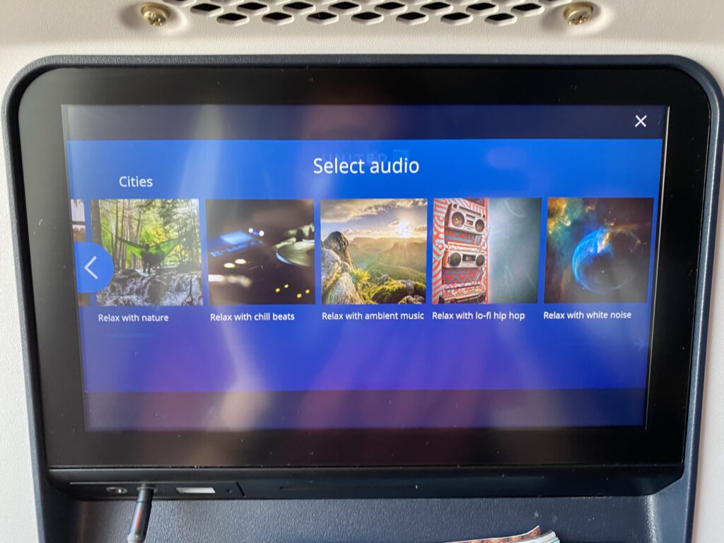 Panasonic seatback IFE on United Airlines 787-9 economy class seat showing the relax mode options.