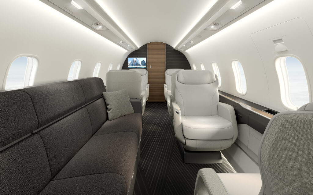 Bombardier Challenger 3500 interior view with a long couch in grey. and some single white seats.