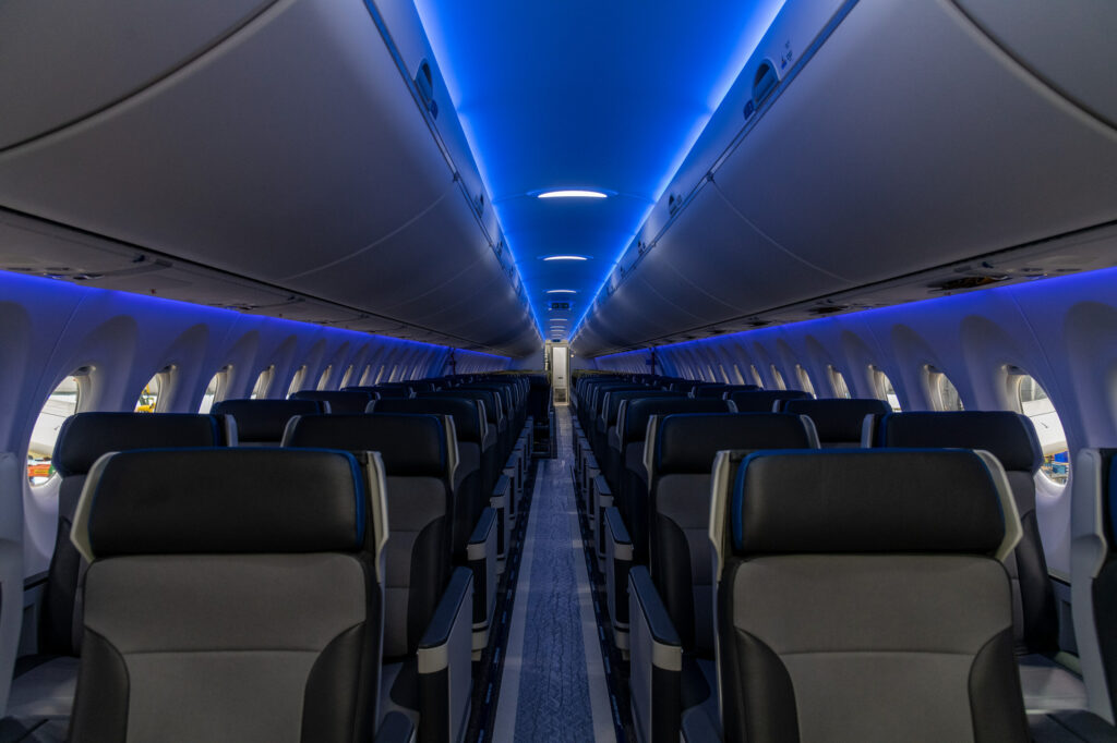 Blue mood lighting seen down the length of the Breeze A220. A total 60 seats up front are of the premium recliner variety