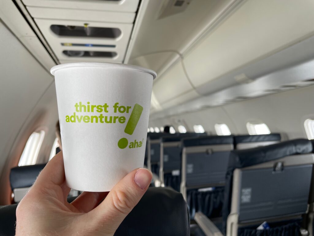 An aha! branded paper cup being held up.