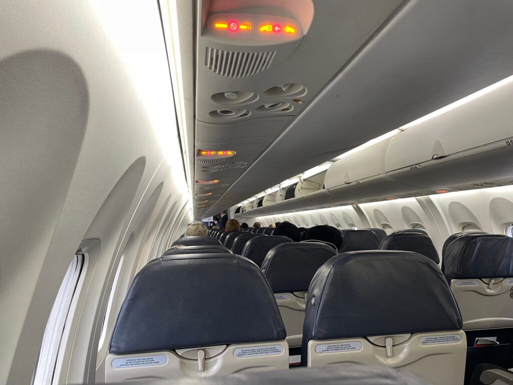 Interior of the Q400 with 2-2 seating, and small overhead bins