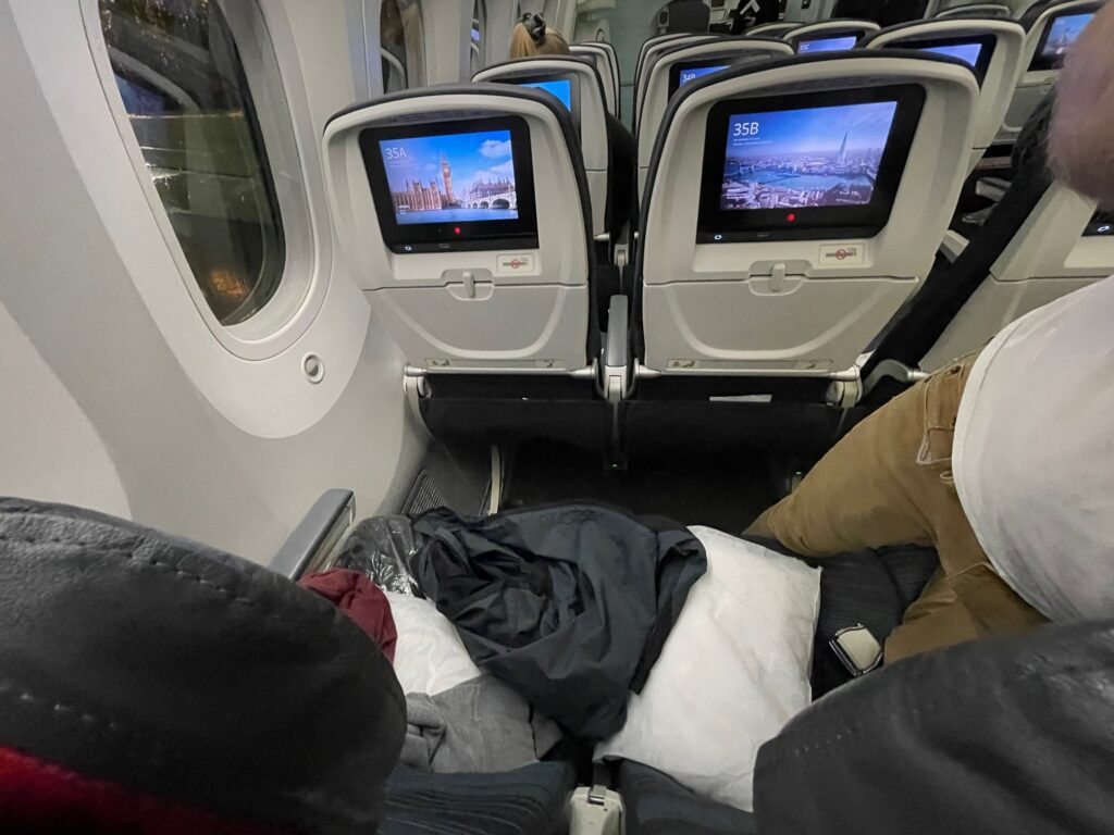 Interior of the Air Canada Boeing 787-9 with IFE screens, and a seat with the author's possessions in view