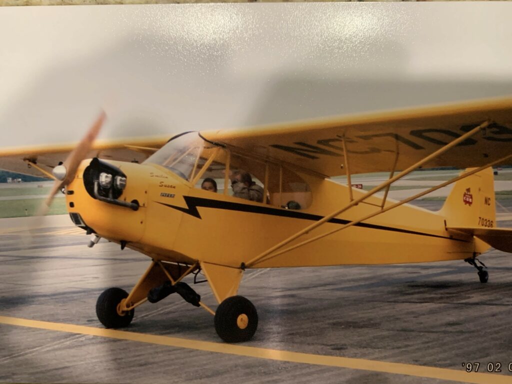 Caroline flying with her grandfather's friend in the Piper Cub