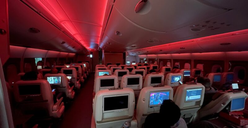 Emirates A380 cabin in economy class with red LED lighting.
