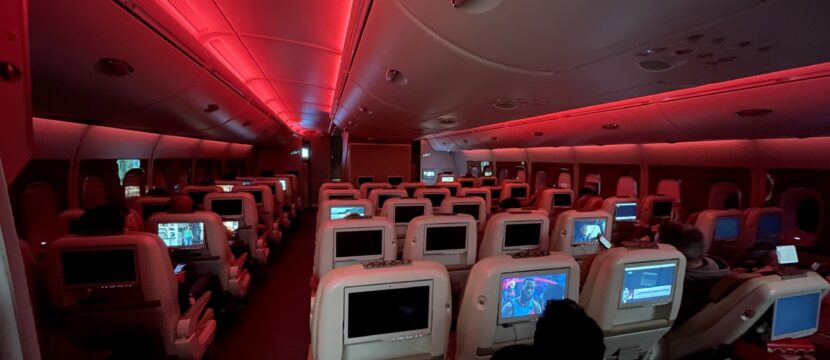 Emirates A380 cabin in economy class with red LED lighting.
