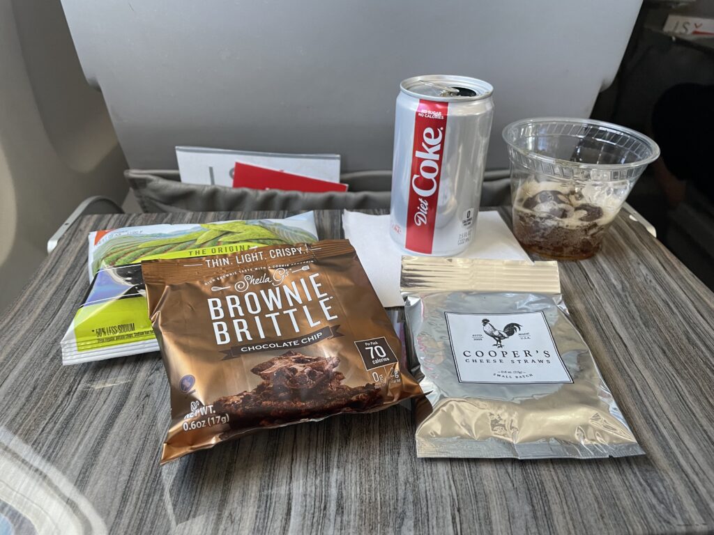 Snack and drink displayed on a JSX tray table.