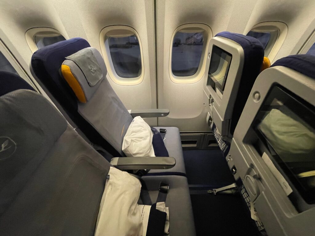 Lufthansa Boeing 747-400 economy class seat with a pillow and blanket waiting for its occupant