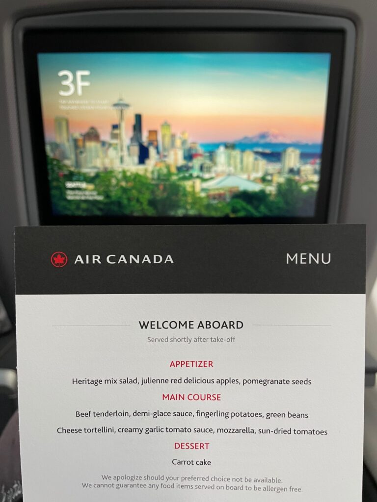 Air Canada's business class menu featuring an appetizer, main course options and carrot cake for dessert