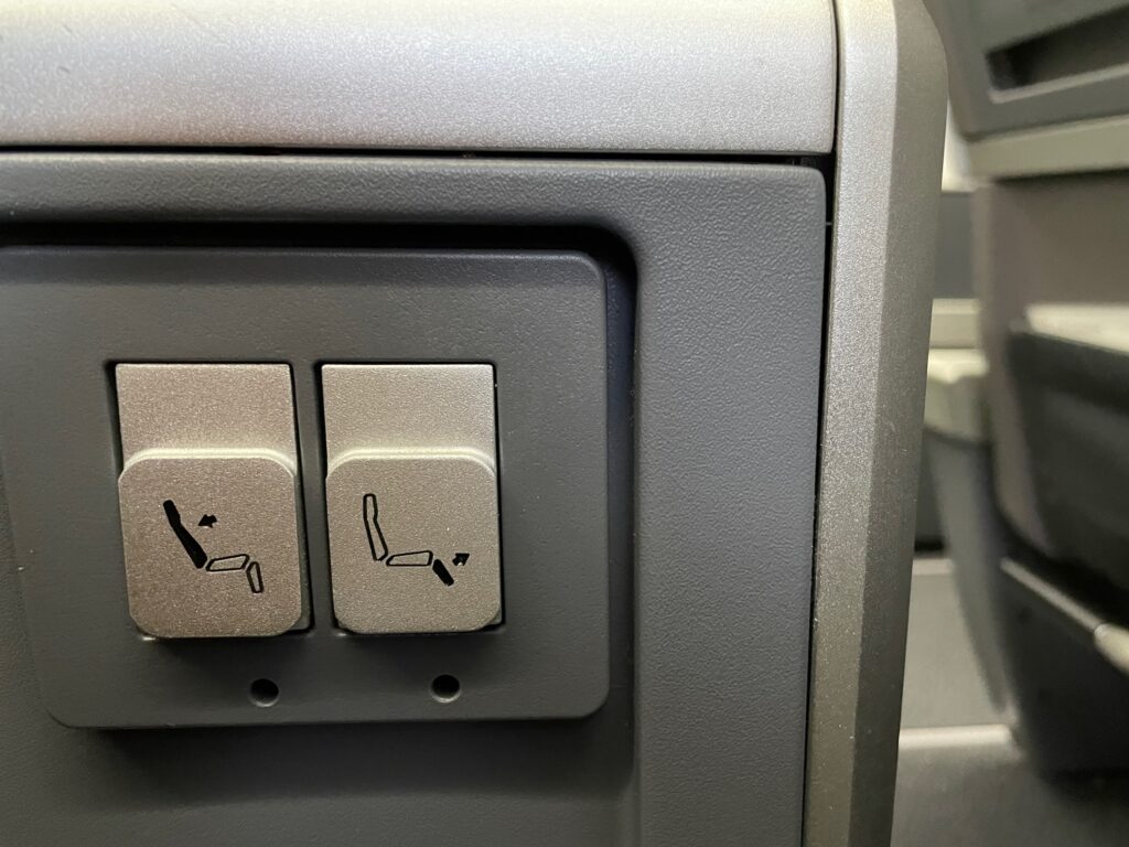 Two buttons in the armrest to control the seat