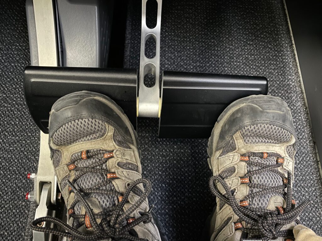 Air Canada A220-300 business class footrest; the author's feet are in view