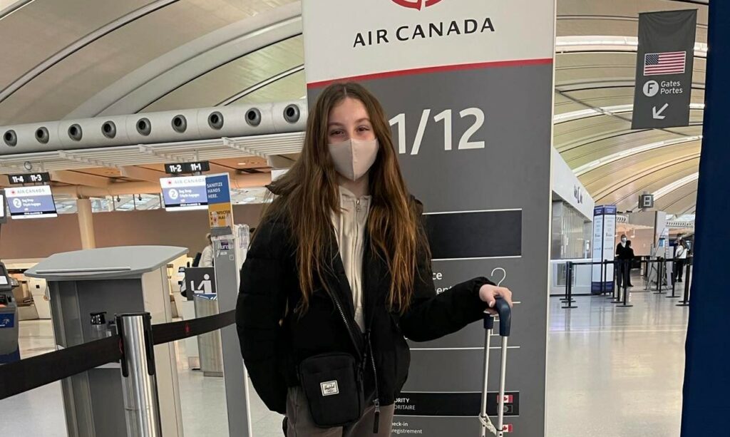 Young girl masked at Toronto Pearson Airport