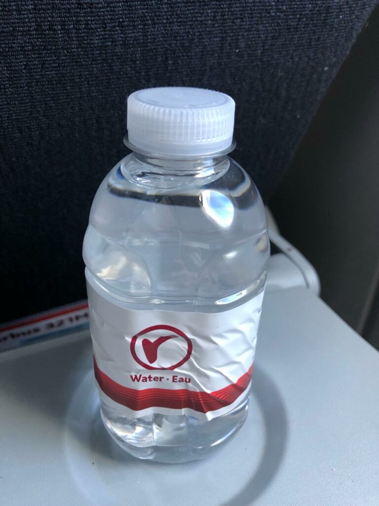 Bottle of water on the tray table.