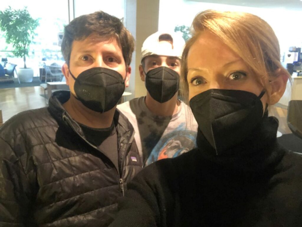 A female and two males taking a selfie with N95 Masks on.