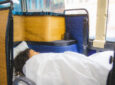 The napaway butterfly seat is in the lay flat position. A woman is lying down with a white blanket and pillow