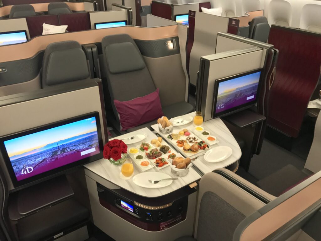 Qatar Airways Qsuite is pictured here all set up for meal time. 