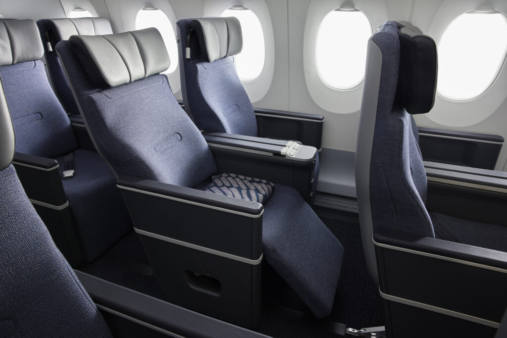 The HAECO Vector premium class seat on finnair shows the leg rest ejected.