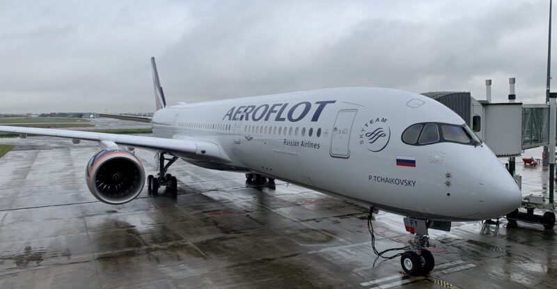 Aeroflot A350 parked at the gate for loading. It is a rainy day.