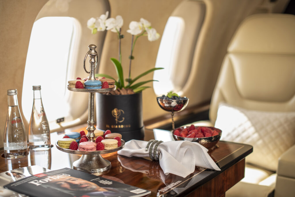 A beautiful spread of food and flowers on a table aboard the Global 6000