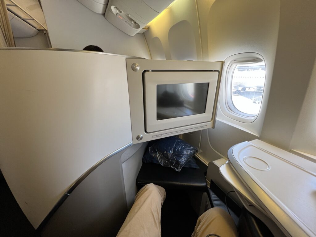 A man's legs are stretched out in the Air France Business Class Seat. 