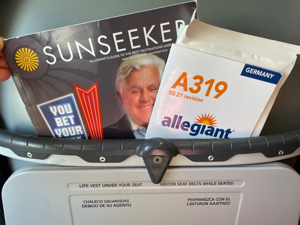 Literature pocket on the back of the aircraft seat. An A319 safety card and a sunseeker inflight magazine are displayed. 