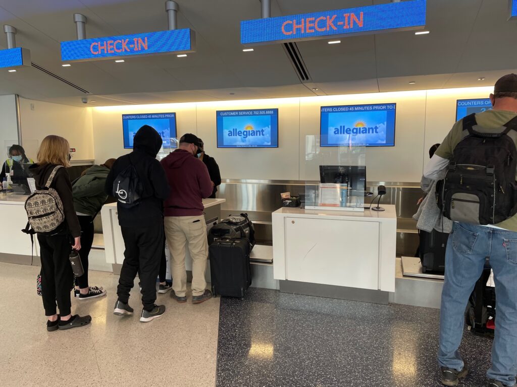 Allegiant check-in at LAX. People are standing in line to check-in for their flights.