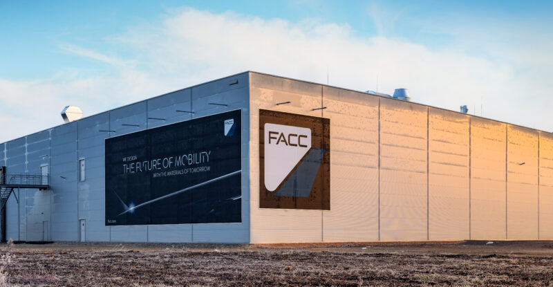 The new FACC production facility is pictured here on the backdrop of a bright blue sky.